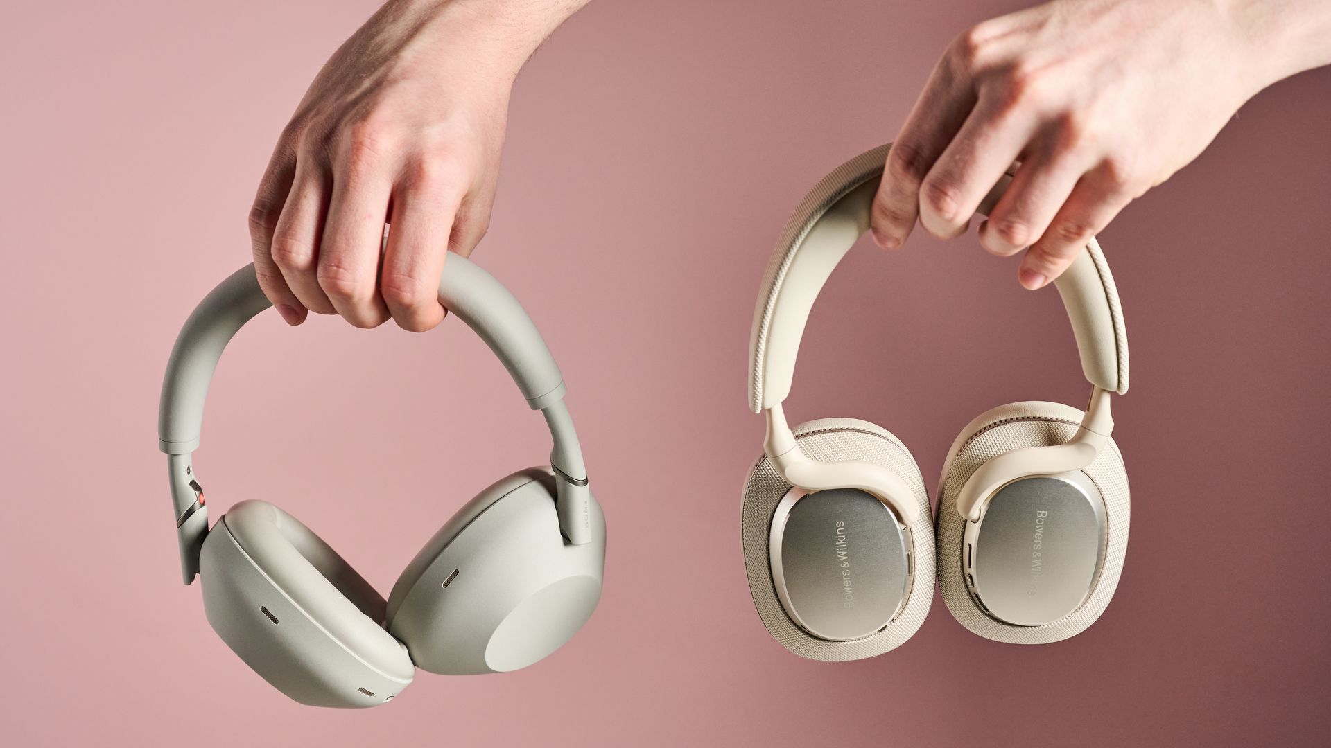 Person holding Sony WH-1000XM6 and Bowers &amp; Wilkins Px7 S3