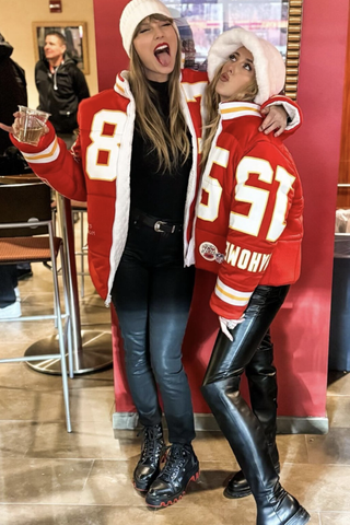 Taylor Swift poses with Brittany Mahomes at a Chiefs game wearing a custom jacket