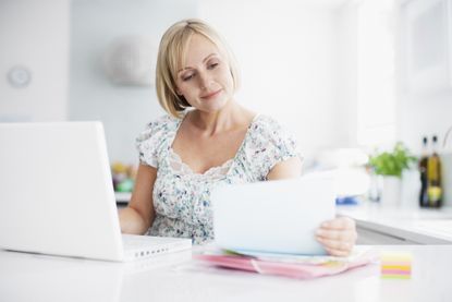 Woman paying bills online with laptop