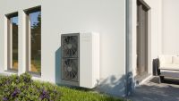cream heat pump on outside wall of home with cream rendered walls and grass area in front of heat pump