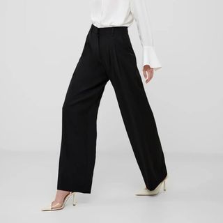 Flat lay image of woman wearing black tailored trousers