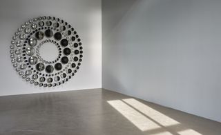 Mirrored art work on wall resembling the moons phases
