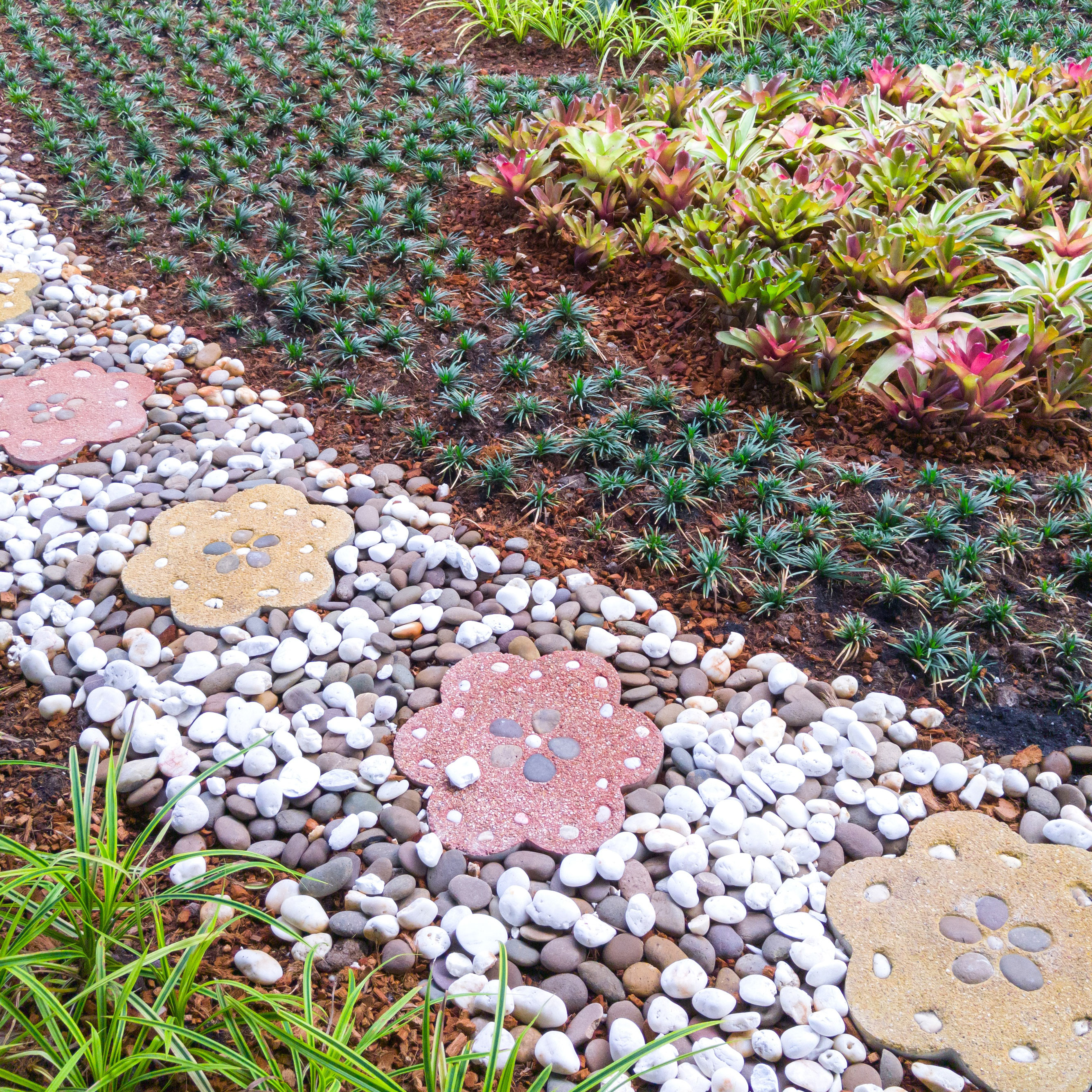 garden path with gravel and colored flower stepping stones