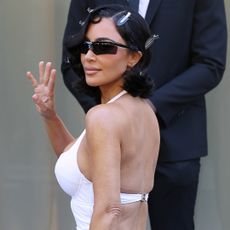 Kim Kardashian walked the Balenciaga Couture Week runway in a skin-tight lingerie dress and a fur coat