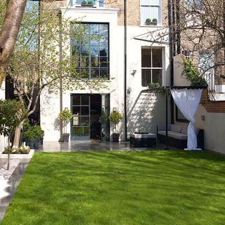house exterior with lawn and seating area