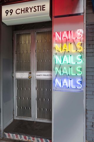 Front door and neon sign of Vanity Projects nail salon New York