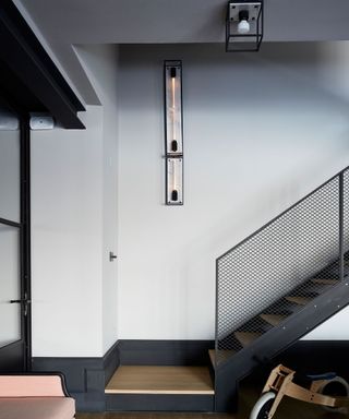 Hall and staircase with wooden treads and black metal baluster and structure