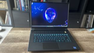 Alienware M16 gaming laptop open on a wooden table