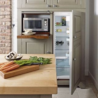 kitchen area with wooden table and fridge