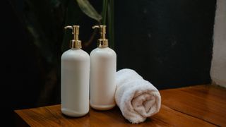 two ceramic jars next to towel in bathroom