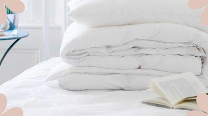 Bed with fresh sheets and duvet in a pile to support an article for how often should you wash your mattress protector