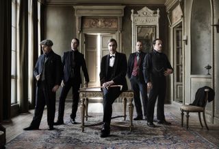 Opeth 2024 suited in 1920s evening wear to promote their new studio album, The Last Will And Testament [L-R]: Martin Mendez (bass), Waltteri Väyrynen (drums), Mikael Åkerfeldt (vocals/guitar), Joakim Svalberg (keys), Fredrik Åkesson (lead guitar).