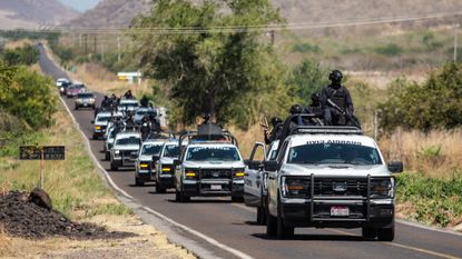 Members of the local guard patrol a highway in Tierra Caliente, Mexico.