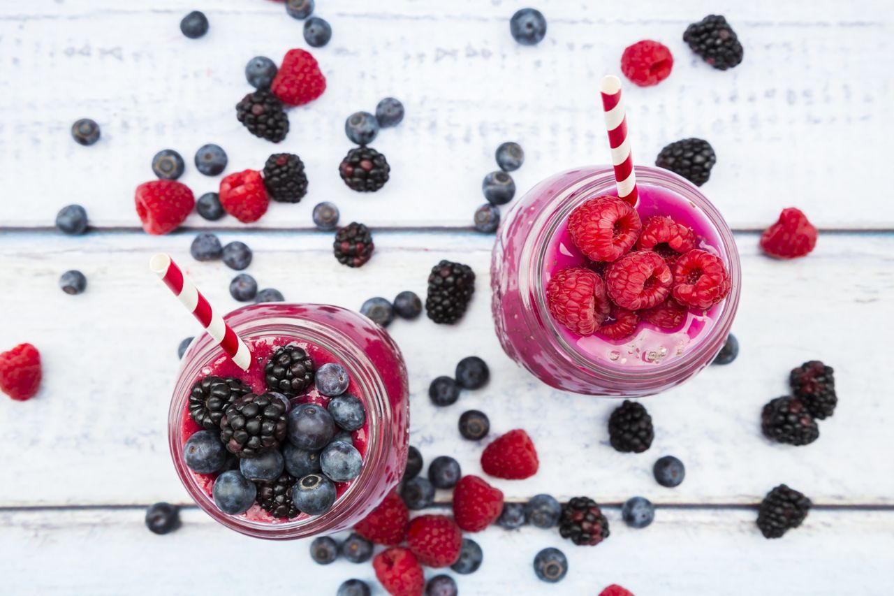 Two glasses of different fruit smoothies