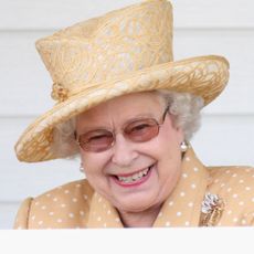 Queen Elizabeth II laughs in the Royal Box as she attends the Queen's Cup final at Guards Polo Club on June 14, 2009