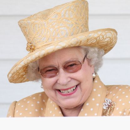 Queen Elizabeth II laughs in the Royal Box as she attends the Queen's Cup final at Guards Polo Club on June 14, 2009