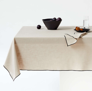 Natural cotton tablecloth with black border.