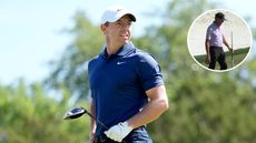 Rory McIlroy hits a tee shot and watches the flight of it