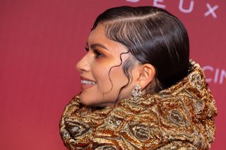 Zendaya on a red carpet with a wet hair look