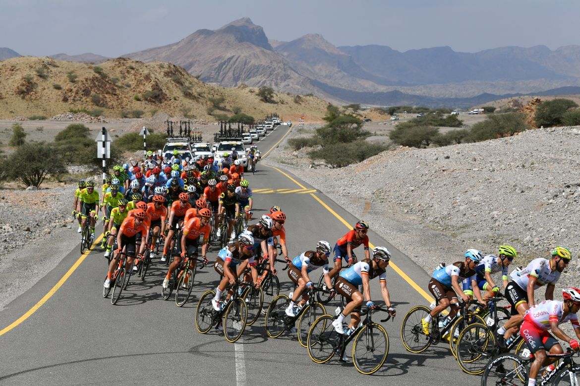 The colours of the peloton stand out in the desert
