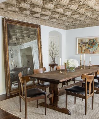 dining room with decorative carved ceiling and dark wood furniture