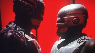 Still from the TV series RoboCop: Prime Directives (2001). Here we see old RoboCop head to head with a new RoboCop against a rest background,