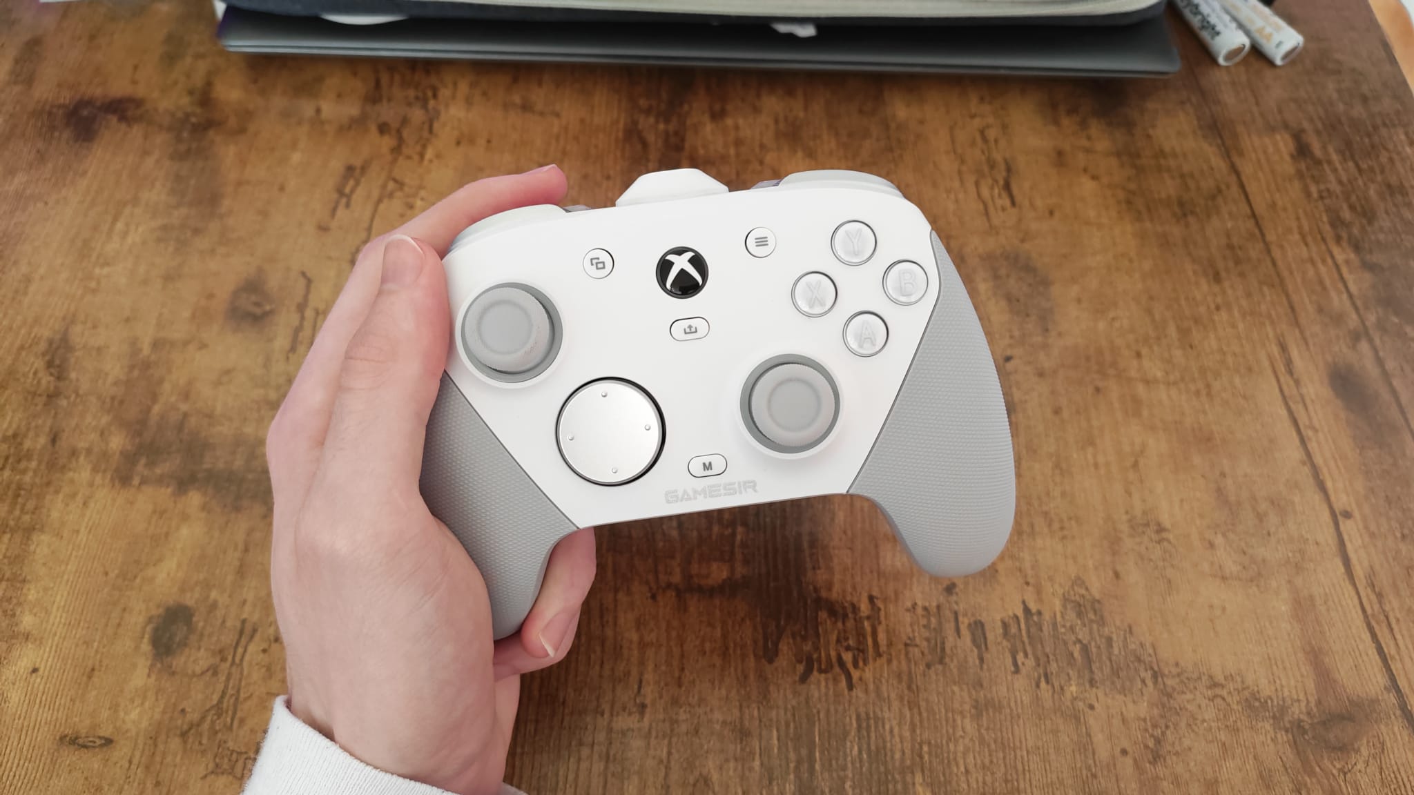 A reviewer holding the GameSir G7 Pro