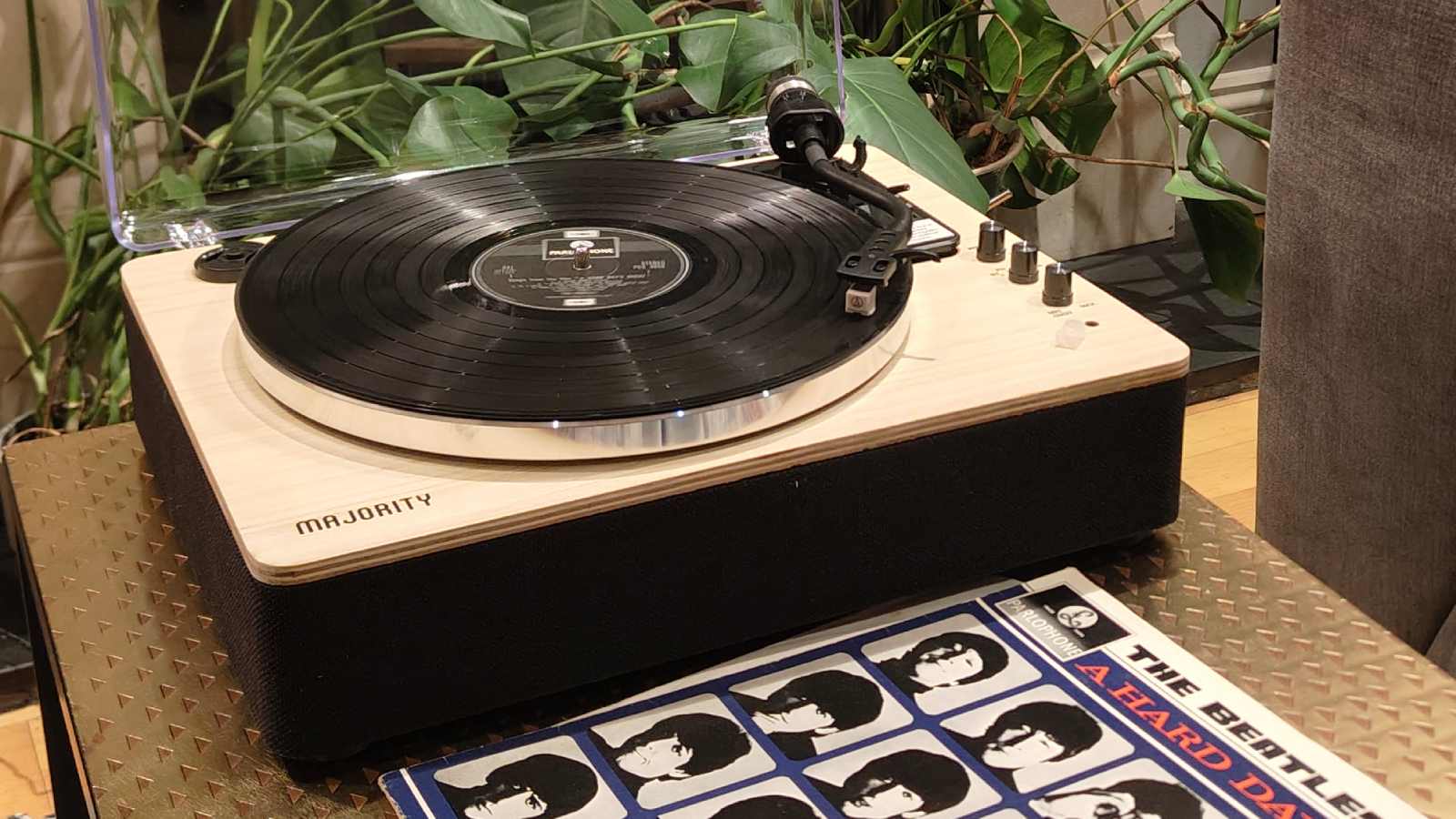 The Majority Folio on a bronze table with plants in the background.