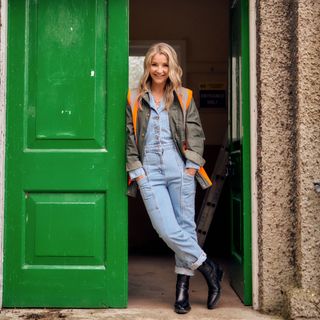 Helen Skelton standing by a bright green door