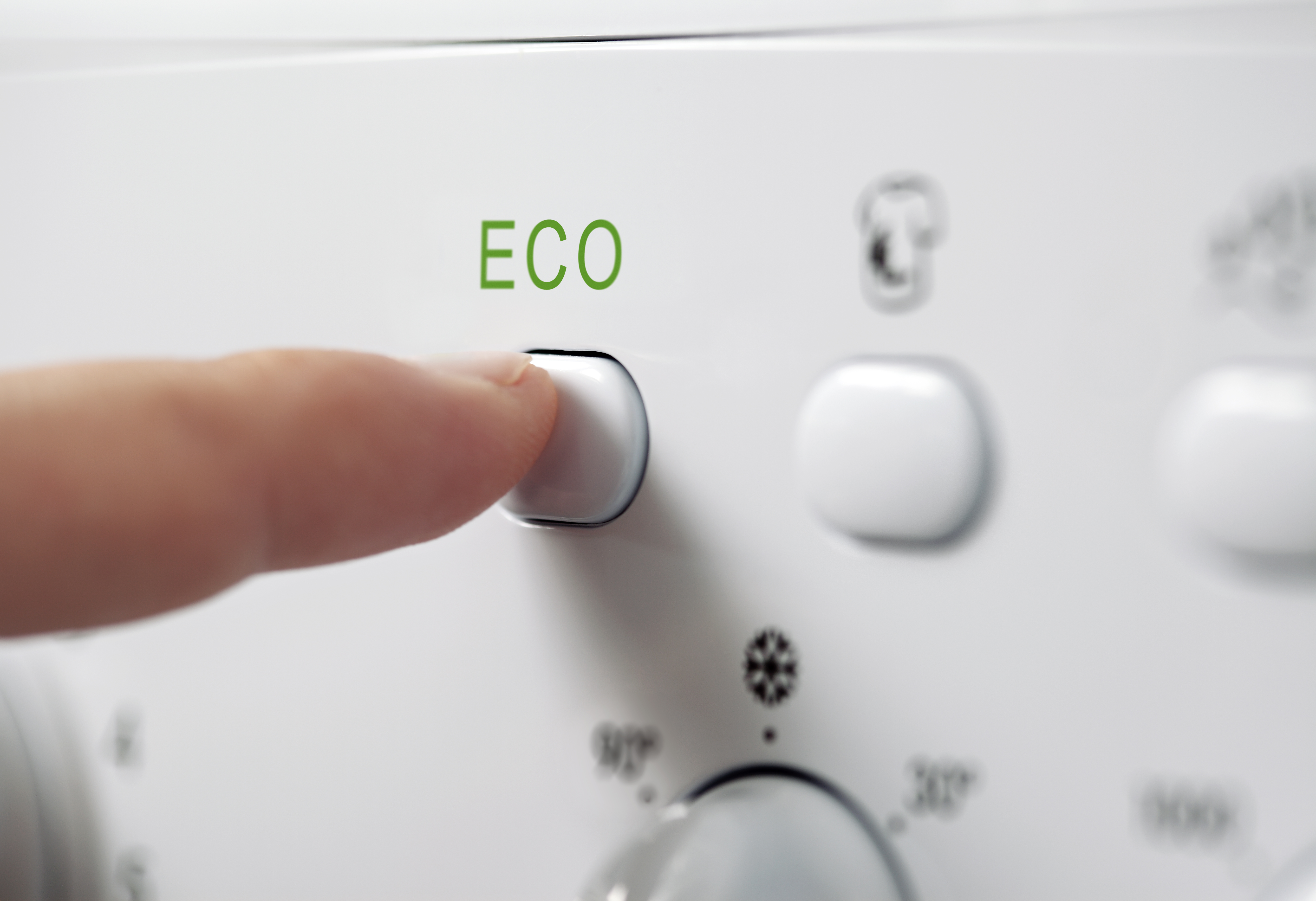 Person presses button on machine which says "eco".