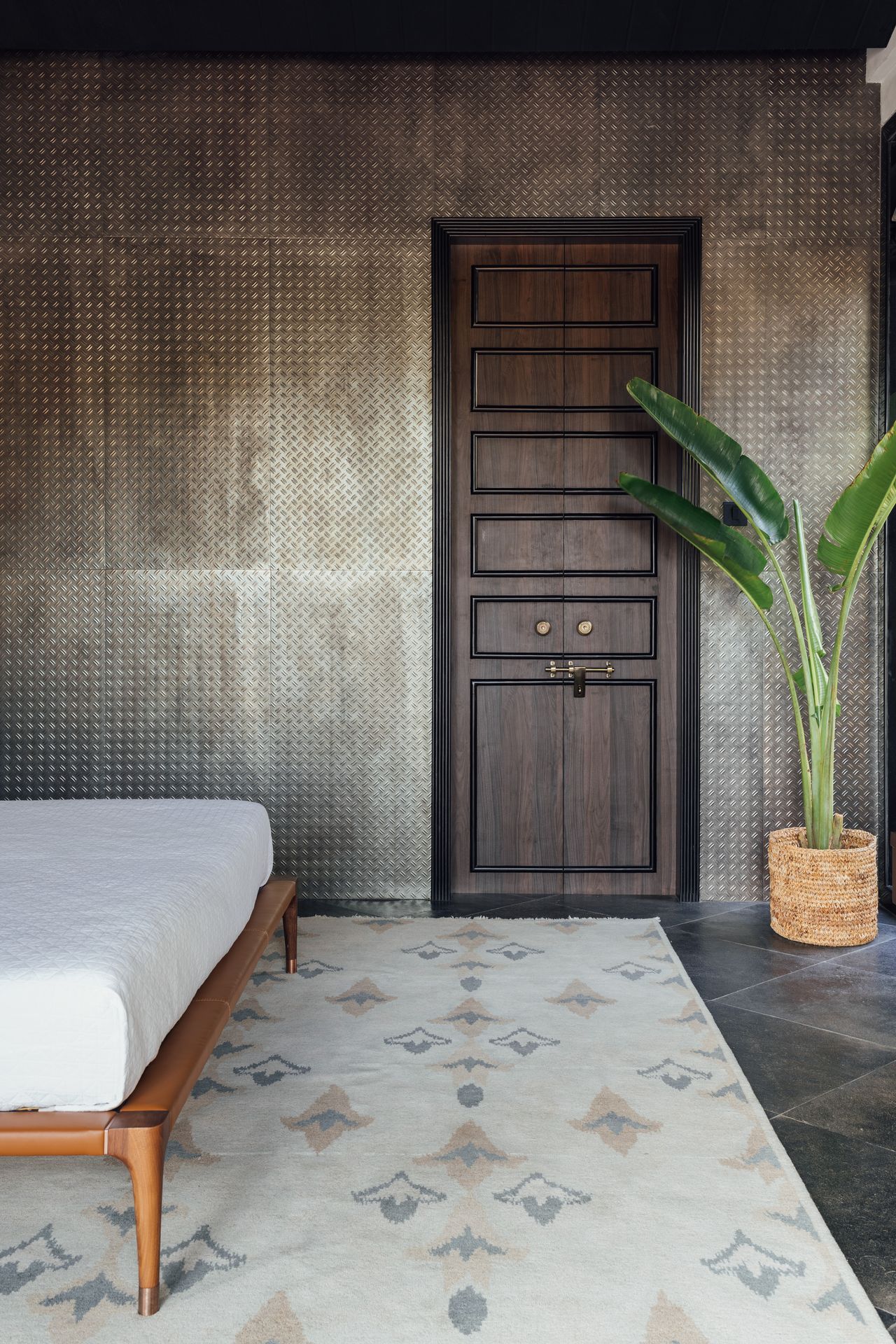 A rustic bedroom with a thin rug