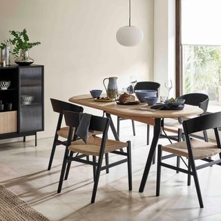 dining room with scandi black chair and arc 8 seater dining table