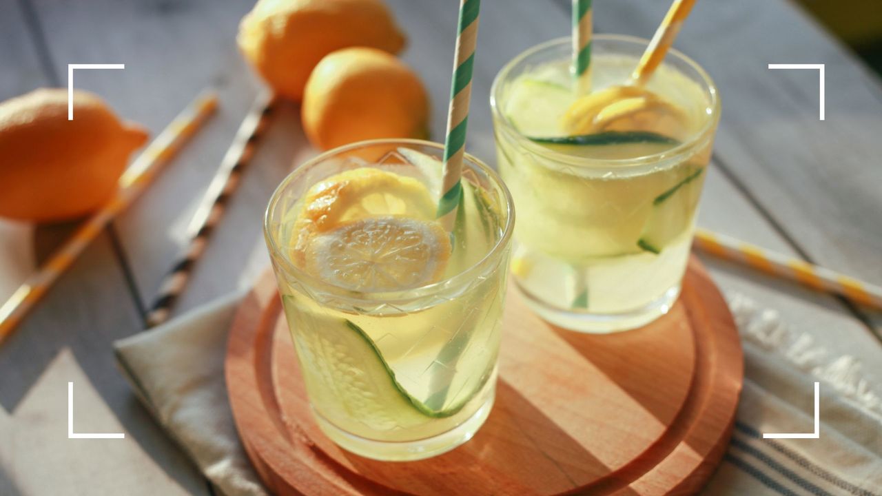 Two glasses of cocktail, the lowest-calorie alcohol in some cases, sitting on wooden chopping board