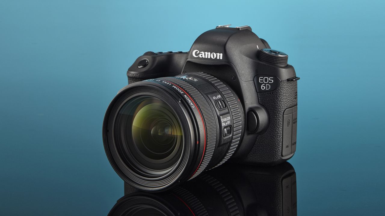 The Canon EOS 6D DSLR camera in a blue studio with its reflection