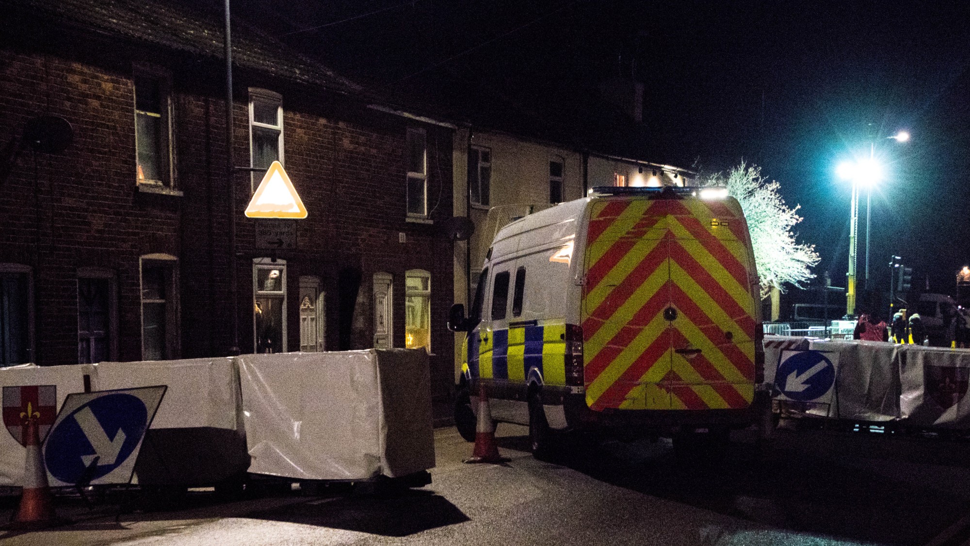A police blockade at night on a British street