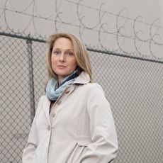 Woman standing next to a prison