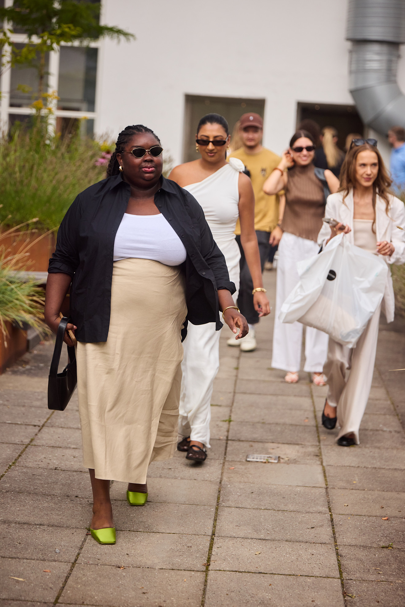 a group of women at copenhagen fashion week wearing neutrals