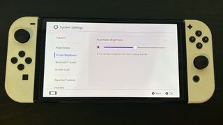 Nintendo Switch console showing screen brightness settings menu