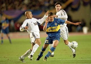 Boca Juniors' Sebastian Battaglia is challenged by Real Madrid's Roberto Carlos in the teams' Intercontinental Cup clash in November 2000.