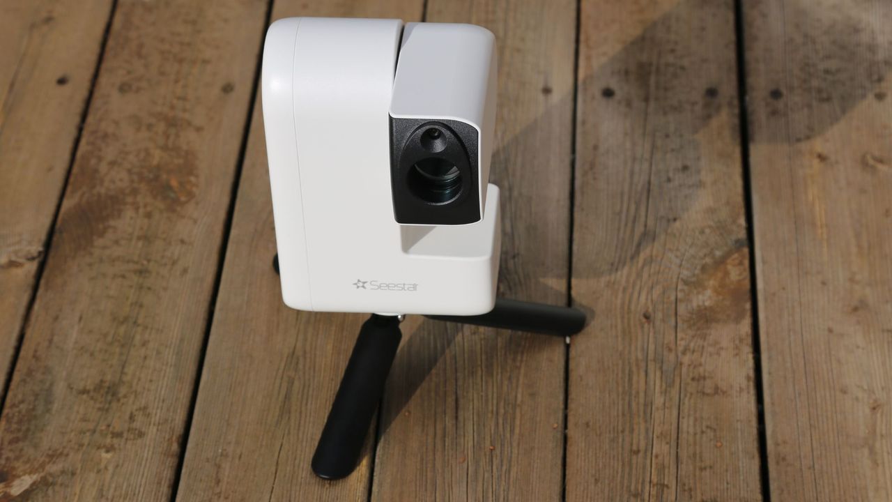 The ZWO Seestar S30 Pro pointing upwards on a wooden table.