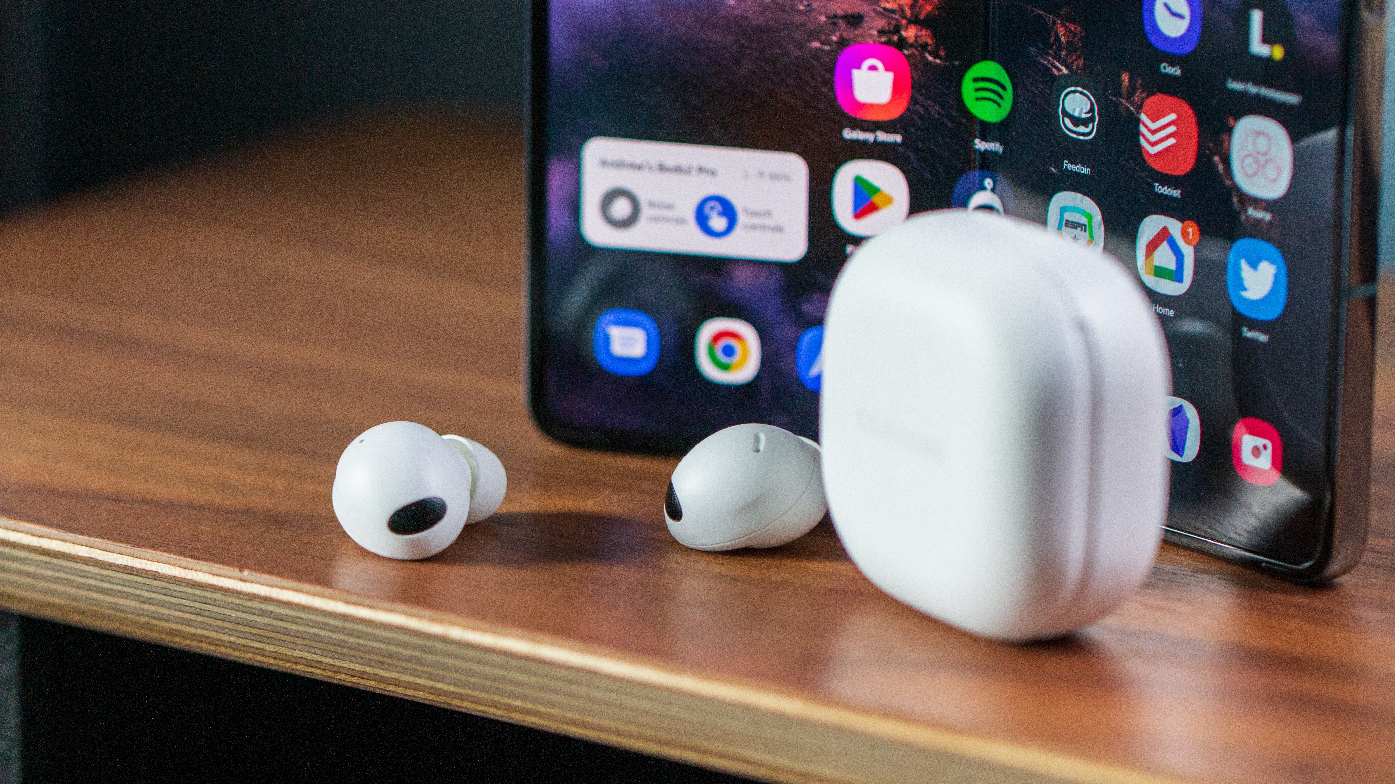 Samsung Galaxy Buds 2 Pro close-up in front of Galaxy Z Fold 4