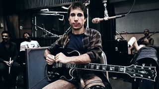 Paul Simon plays guitar during a 1980 recording session on the set of the film "One Trick Pony" in New York City Bakithi Kumalo