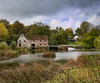A house by a river by Sturminster Newton Mill and River Stour in Dorset
