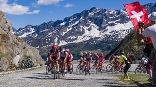 Cyclist in the peleton on the Tour de Suisse with the snowy Alps in the background 