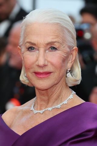 Helen Mirren is pictured with a sleek bun at the "La Plus Precieuse Des Marchandises" (The Most Precious Of Cargoes) Red Carpet at the 77th annual Cannes Film Festival at Palais des Festivals on May 24, 2024 in Cannes, Franc