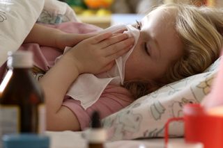 Young girl in bed with symptoms of coronavirus
