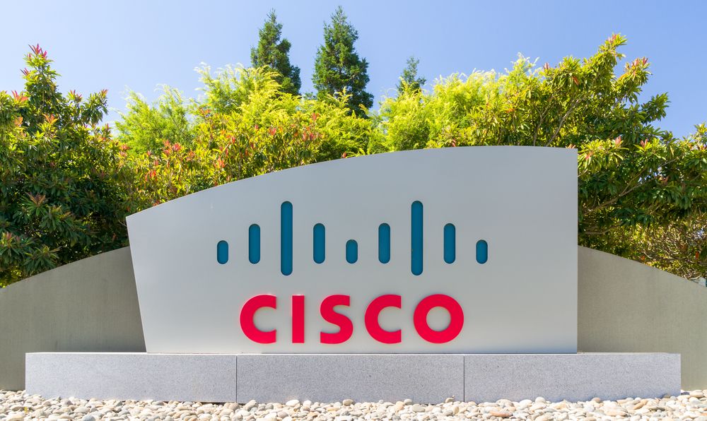 A Cisco sign at the company&amp;#039;s HQ with trees in the background