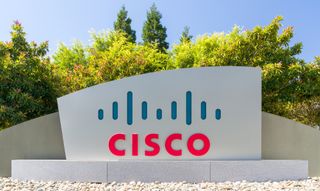 A Cisco sign at the company's HQ with trees in the background