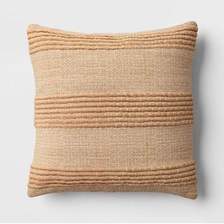 A brown textured woven square throw pillow is one of the best Target fall decor items for a cozy living room.