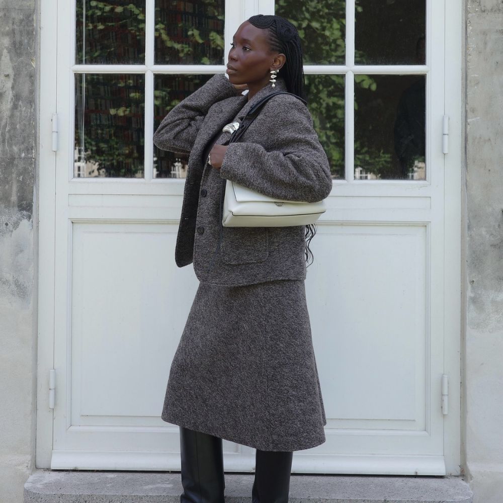 Influencer @daniellejinadu wears black wedge boots with a grey knitted two-piece.